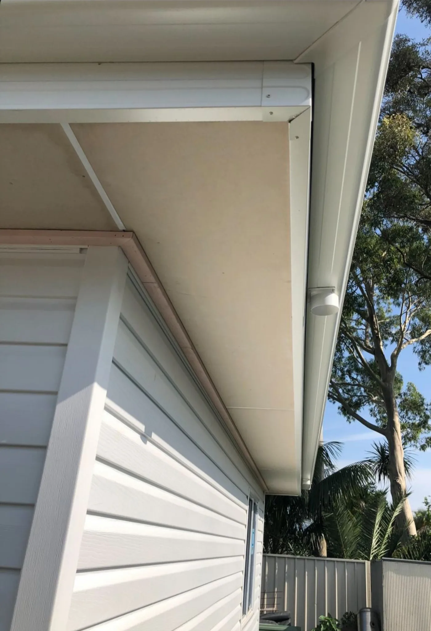 New eaves and fascia detail against a blue sky